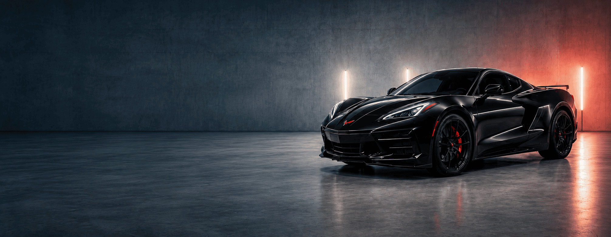Black sports coupe with tinted windows in a blue and red studio